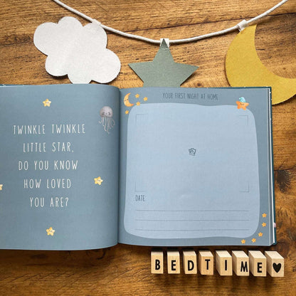 Open book with star-themed text and illustrations on a wooden surface with decorative elements.