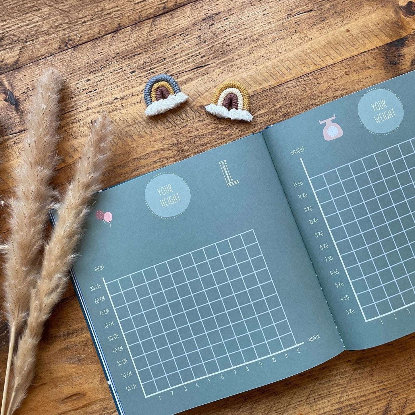 Open book with weight measurement chart on a wooden surface with decorative elements.