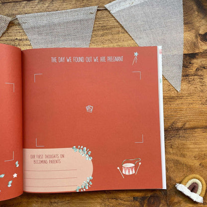Open book with red cover on a wooden surface, featuring text and illustrations.