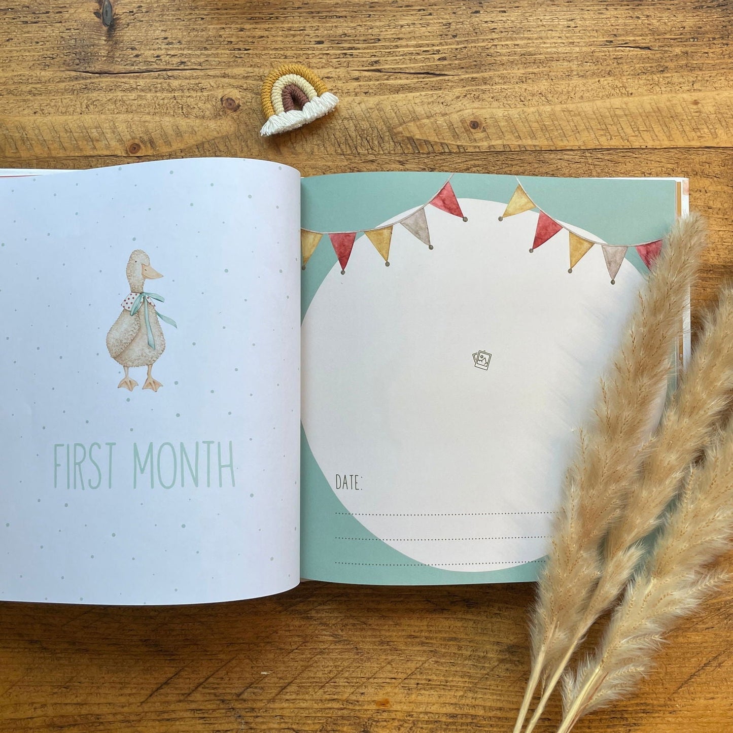 Open book with illustrations of a duck and bunting flags on a wooden surface.