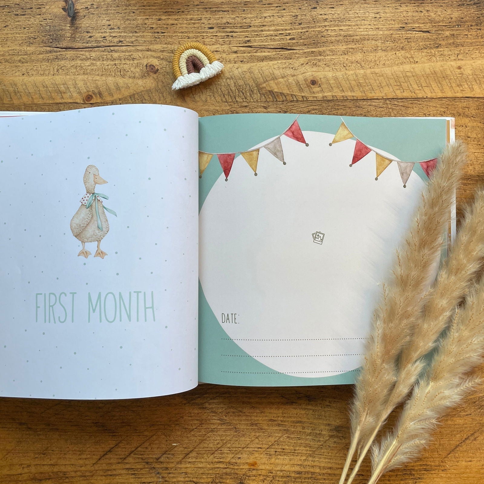 Open book with illustrations of a duck and bunting flags on a wooden surface.