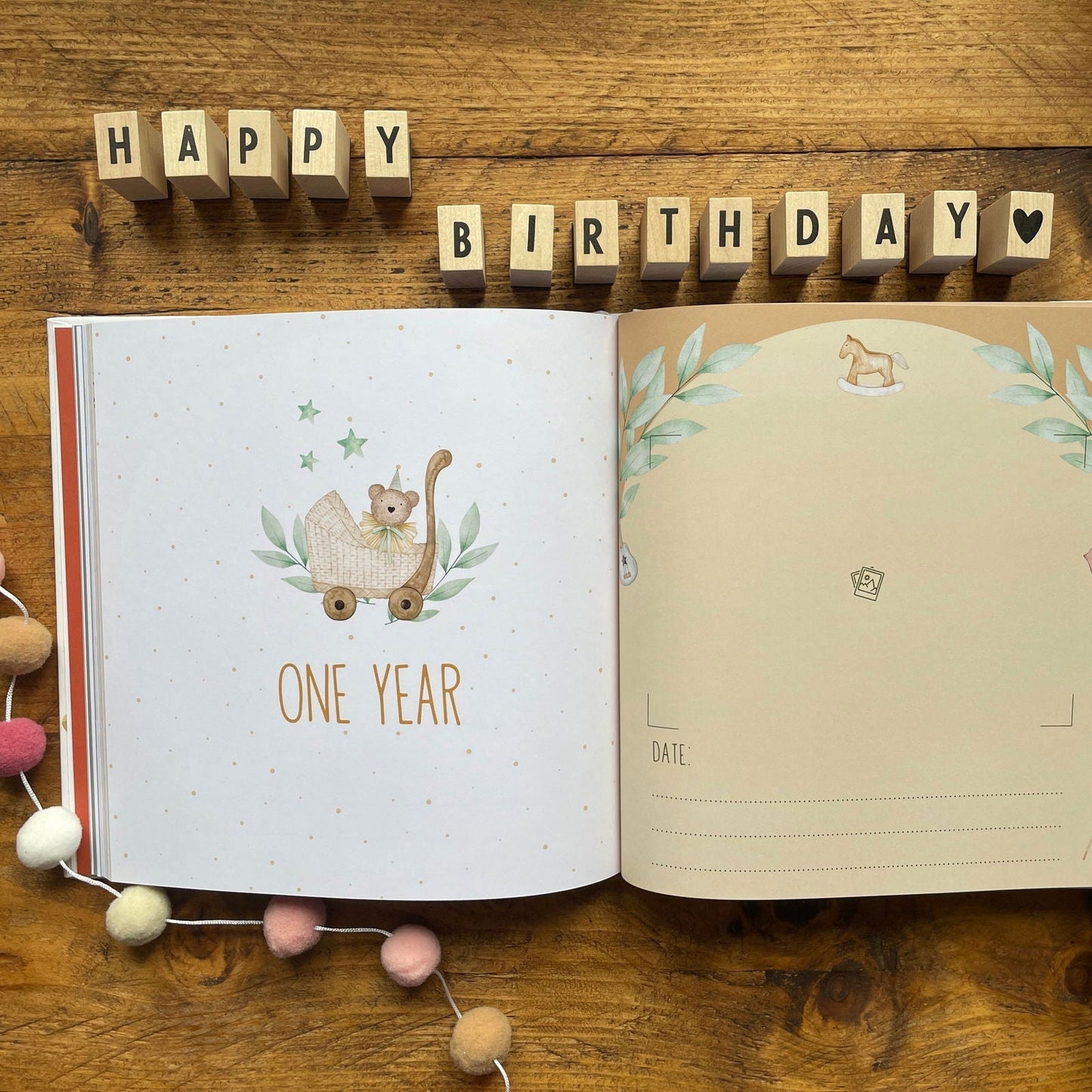Open book with 'Happy Birthday' decoration on a wooden surface