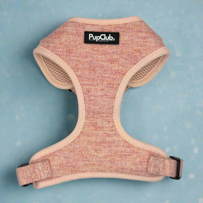 Pink dog harness with 'PupClub' label on a blue background