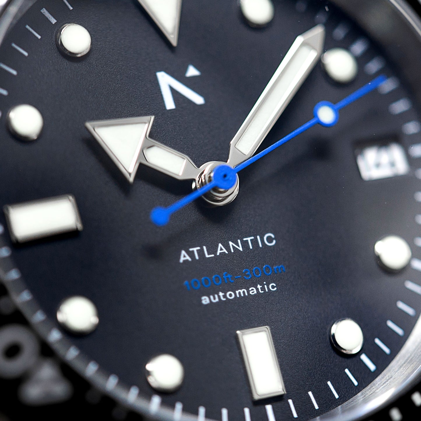 Close-up of an Atlantic watch face with blue second hand