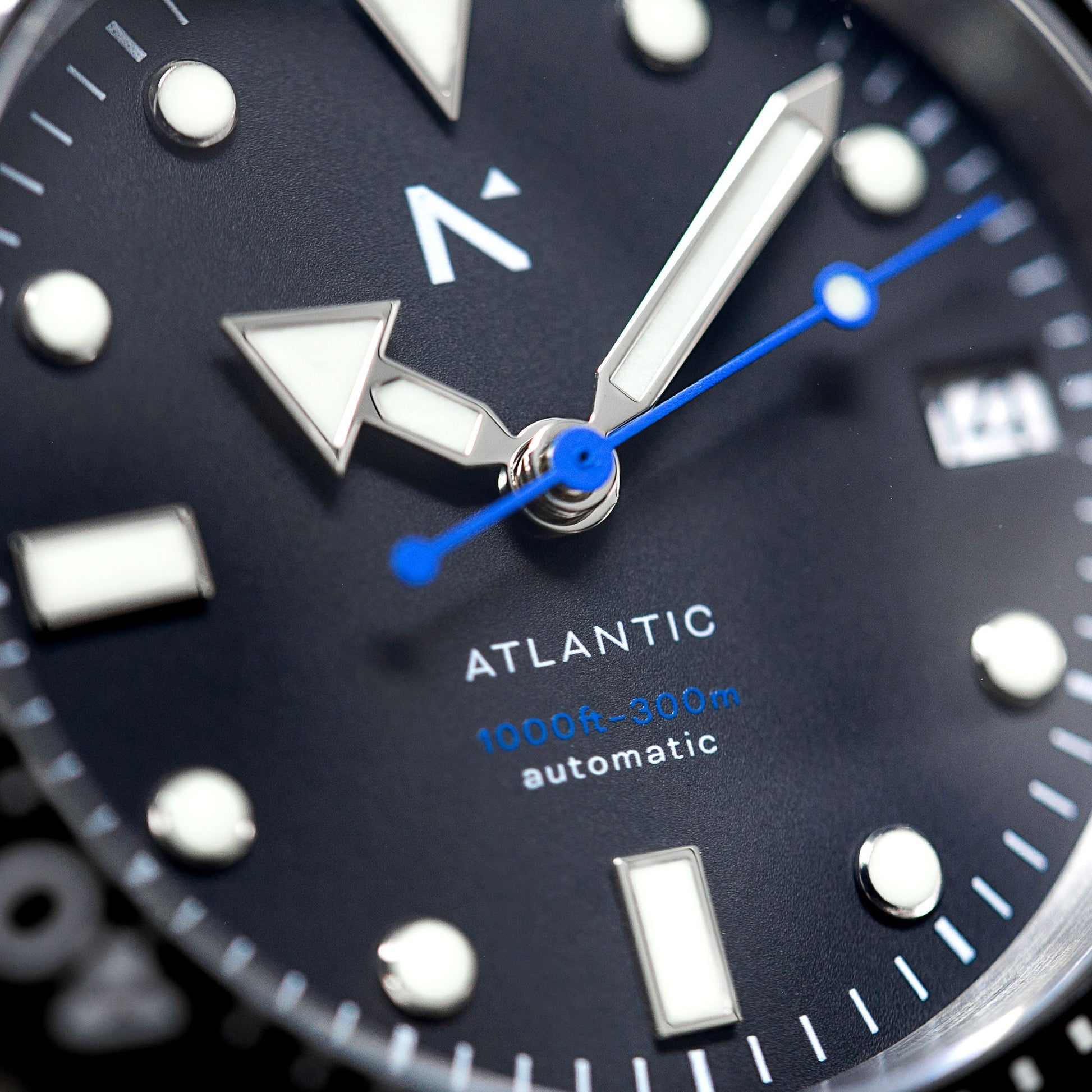 Close-up of an Atlantic watch face with blue second hand