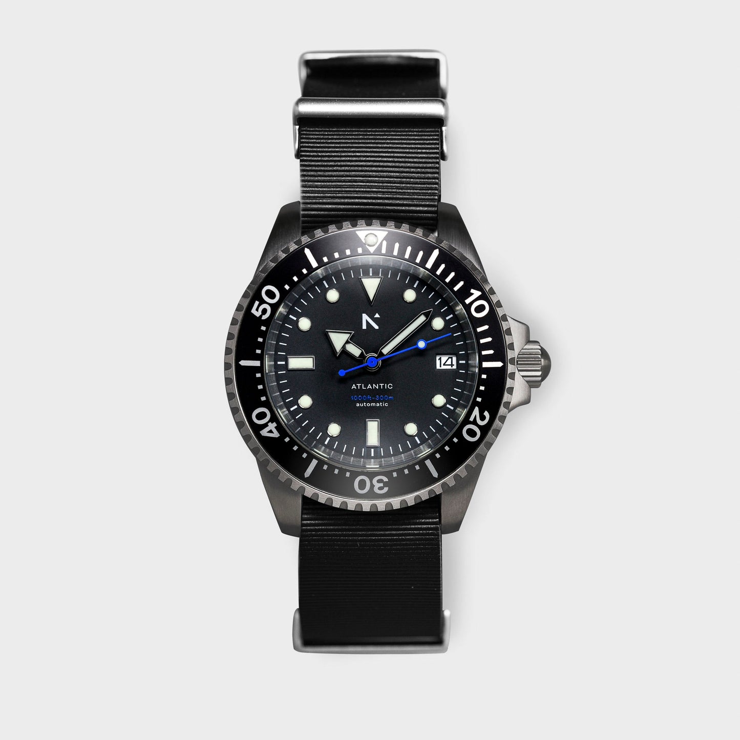 Black wristwatch with a detailed face on a light gray background