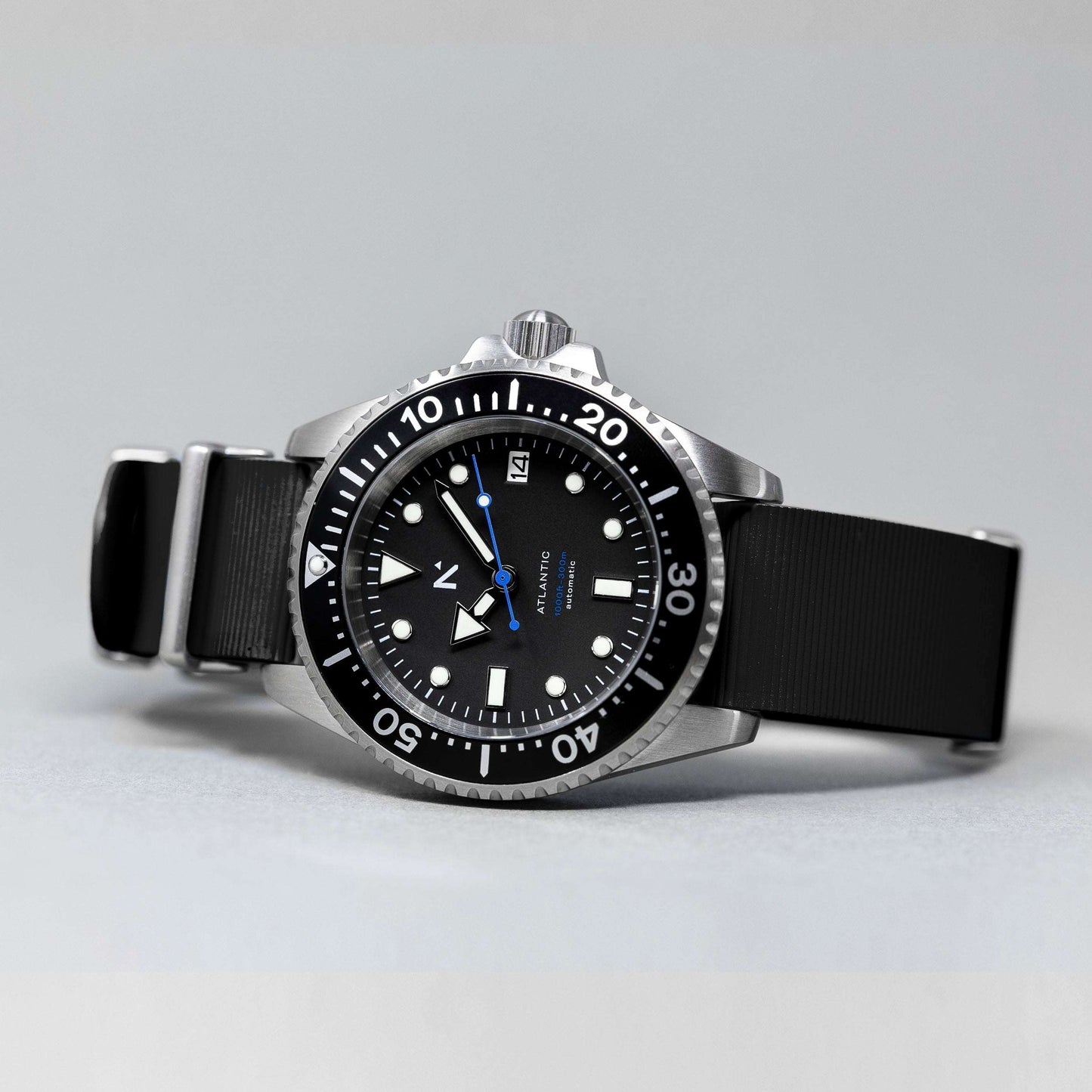 Black wristwatch with a detailed dial on a gray background
