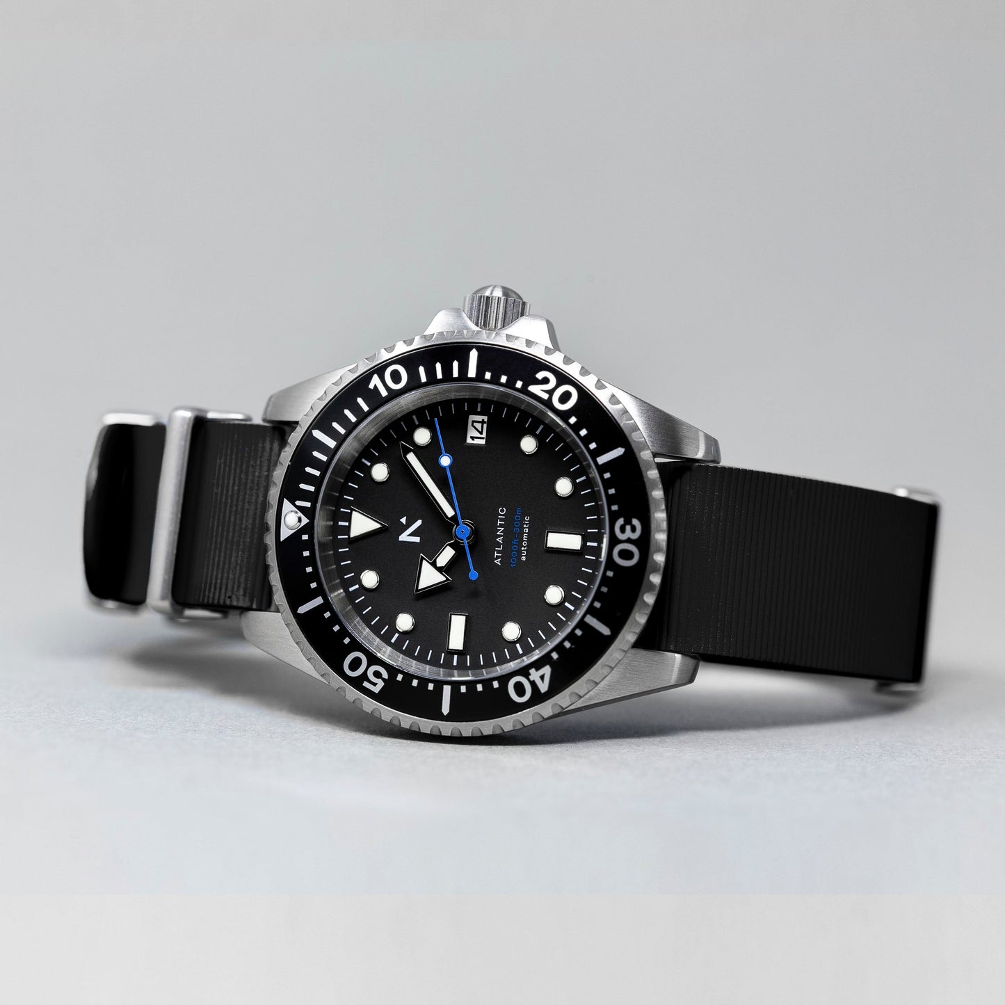 Black wristwatch with a detailed dial on a gray background