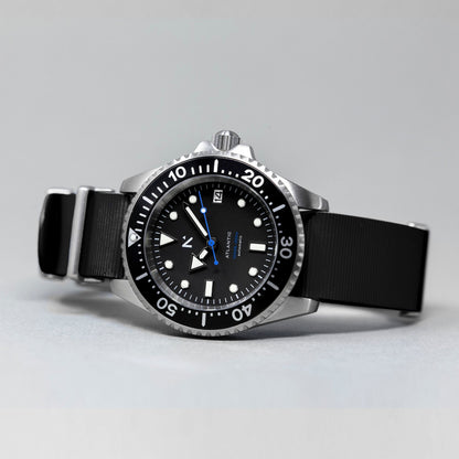Black wristwatch with a detailed dial on a gray background