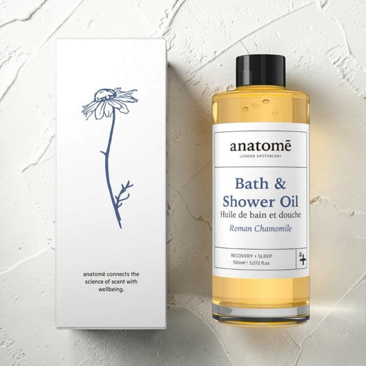 Bottle of anatomé Bath & Shower Oil with a white label on a light background