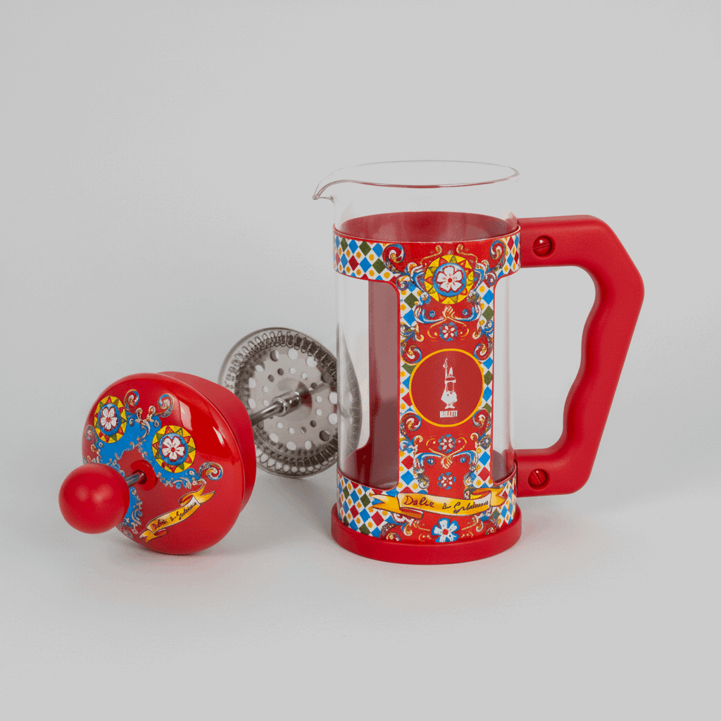 Red cafetiere with colorful patterns on a transparent background