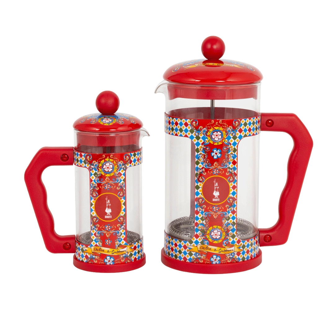 Two red and transparent coffee presses with colorful patterns on a white background