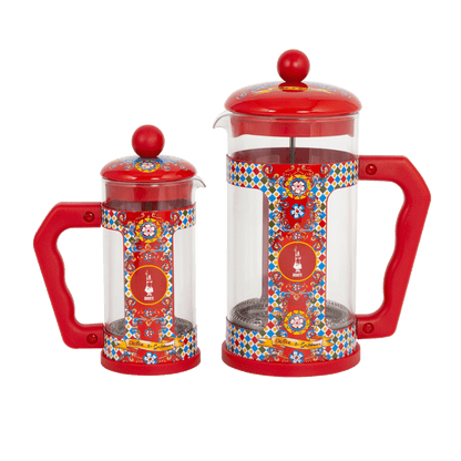 Two red and transparent coffee presses with colorful patterns on a white background