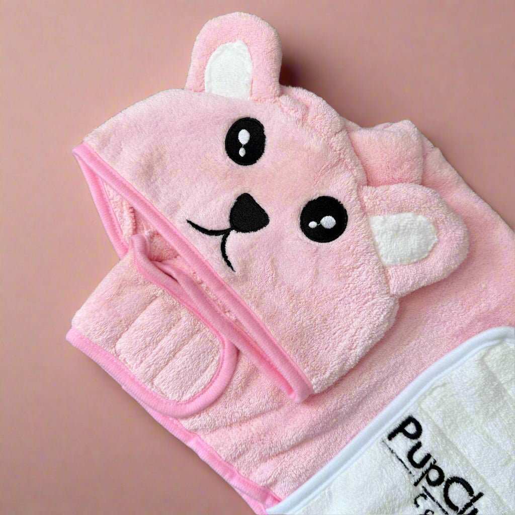 Pink towel with cartoon face design on a pink background