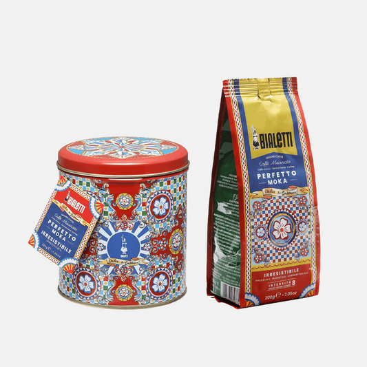 Decorative coffee tin and bag with Bialetti branding on a white background