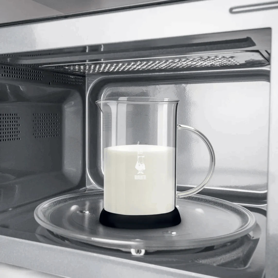 Glass container with a candle inside a microwave oven