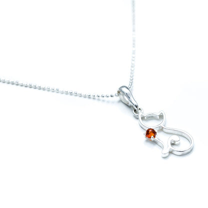 close up of cat necklace on a white background