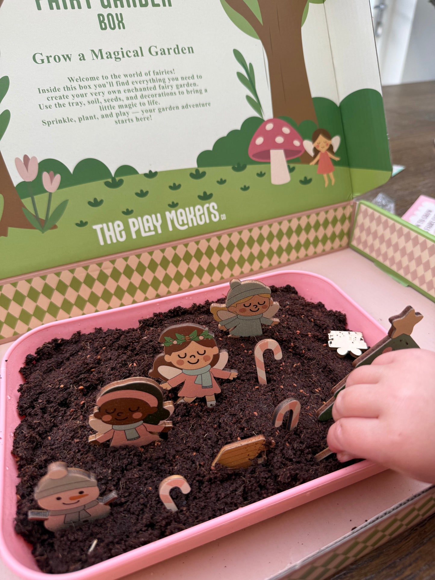 Children's gardening kit with soil and fairy figures, branded 'The Play Makers'.