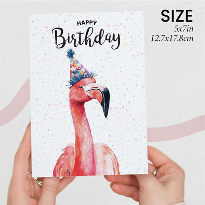 Birthday card with a flamingo wearing a party hat held by a hand, on a light gray background.