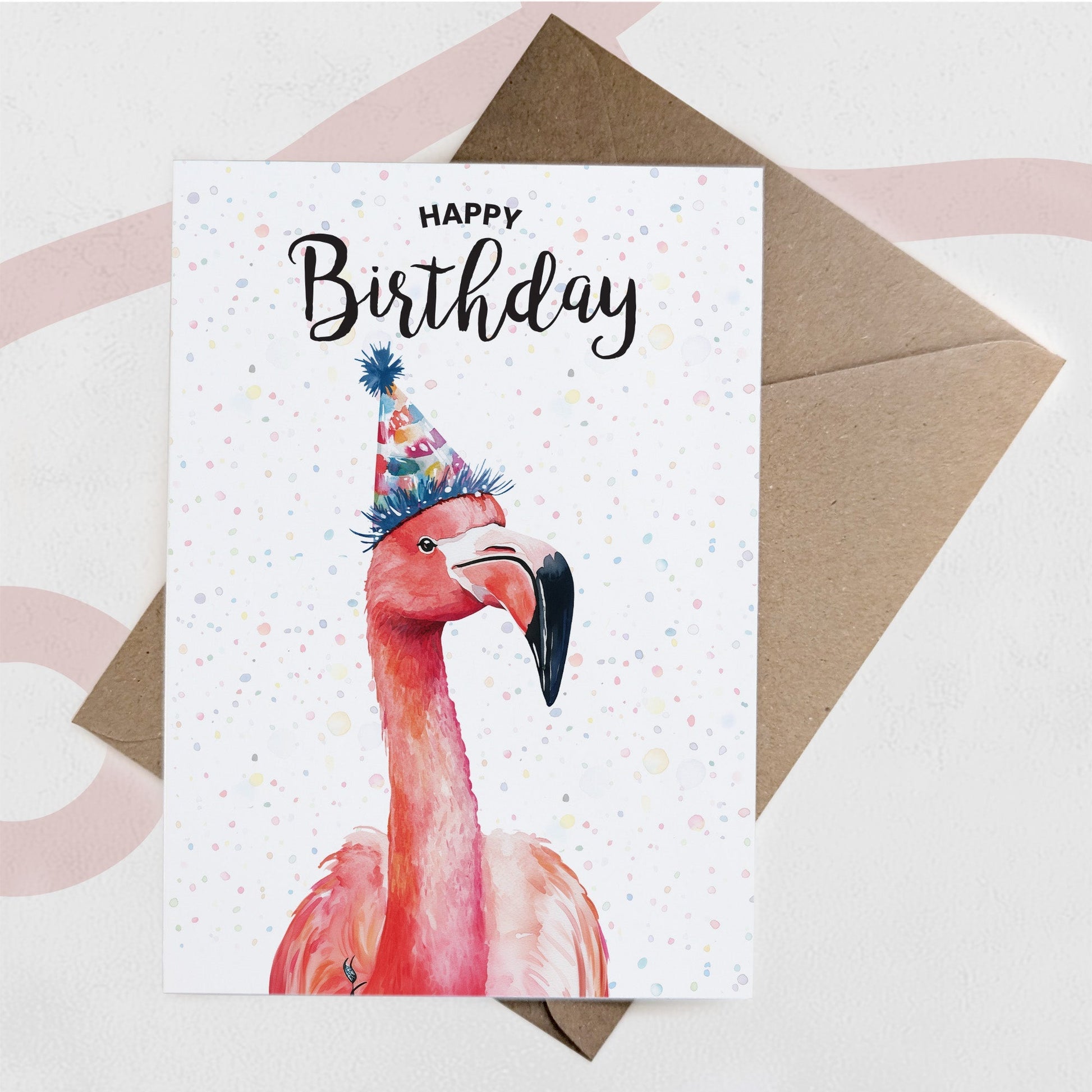 Birthday card with a flamingo wearing a party hat on a white background