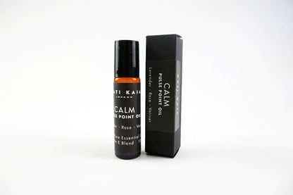 Roll-on bottle and packaging of 'Calm' essential oil on a white background