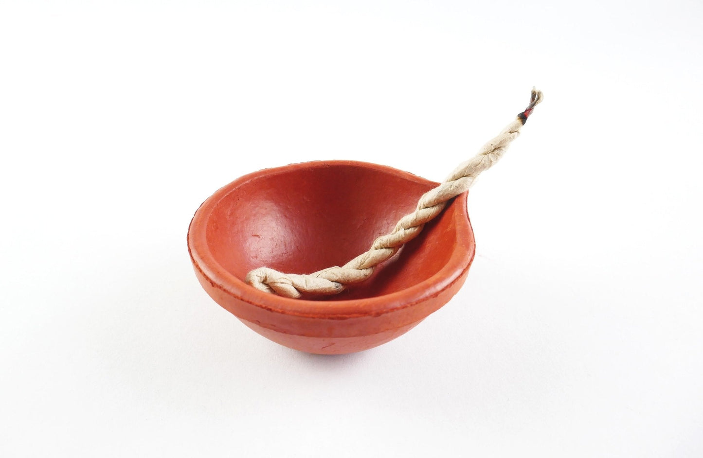 Red ceramic bowl with a rope on a white background