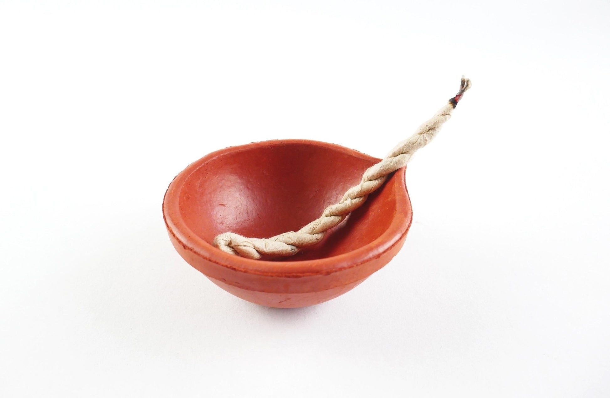 Red ceramic bowl with a rope on a white background