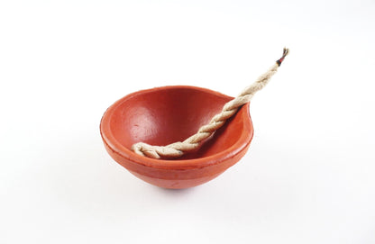 Red ceramic bowl with a rope on a white background