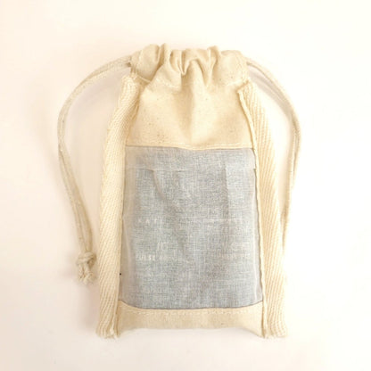 Beige drawstring bag with a gray interior on a light beige background
