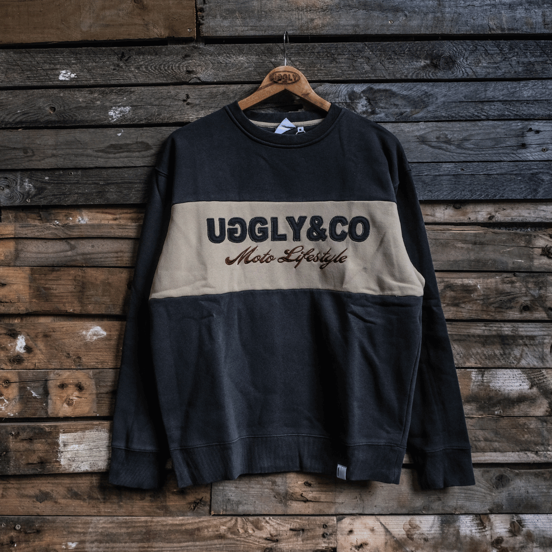 Sweatshirt with 'UGGLY&CO Moto Lifestyle' text on a wooden background