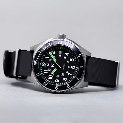 Wristwatch with black strap and green accents on a light gray background
