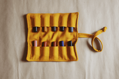 Yellow crayon holder with various crayons on a beige background