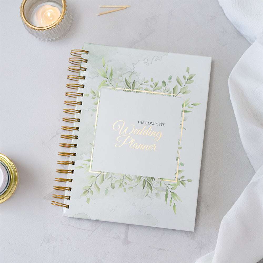 Wedding planner book with decorative cover on a light surface