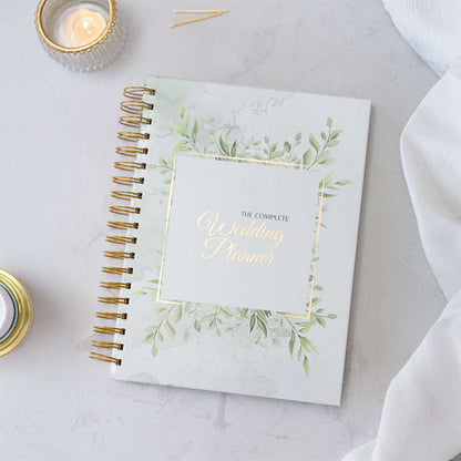 Wedding planner book with decorative cover on a light surface