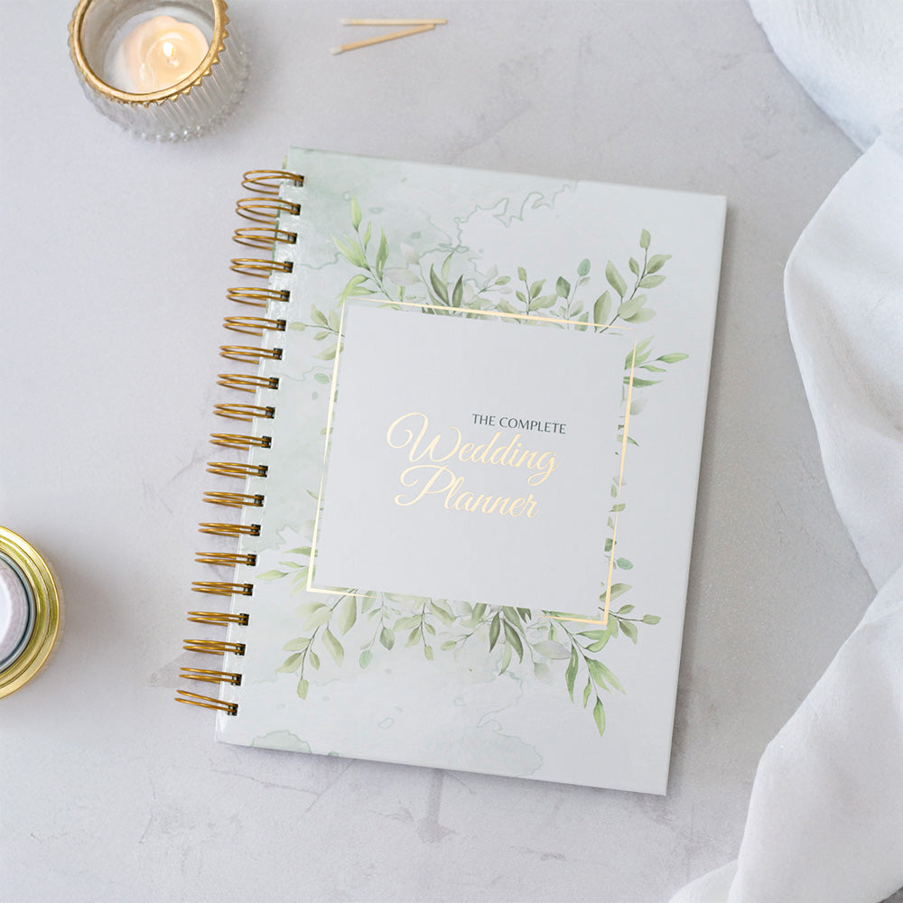 Wedding planner book with decorative cover on a light surface