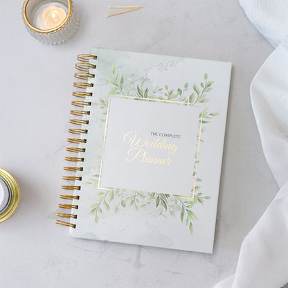Wedding planner book with decorative cover on a light surface