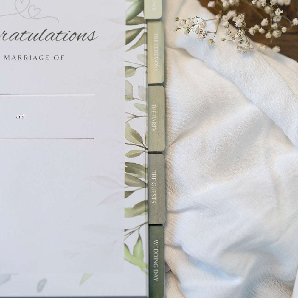 Wedding invitation with greenery design on a white background