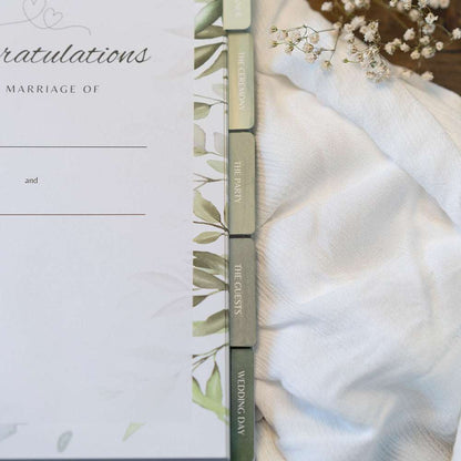 Wedding invitation with greenery design on a white background