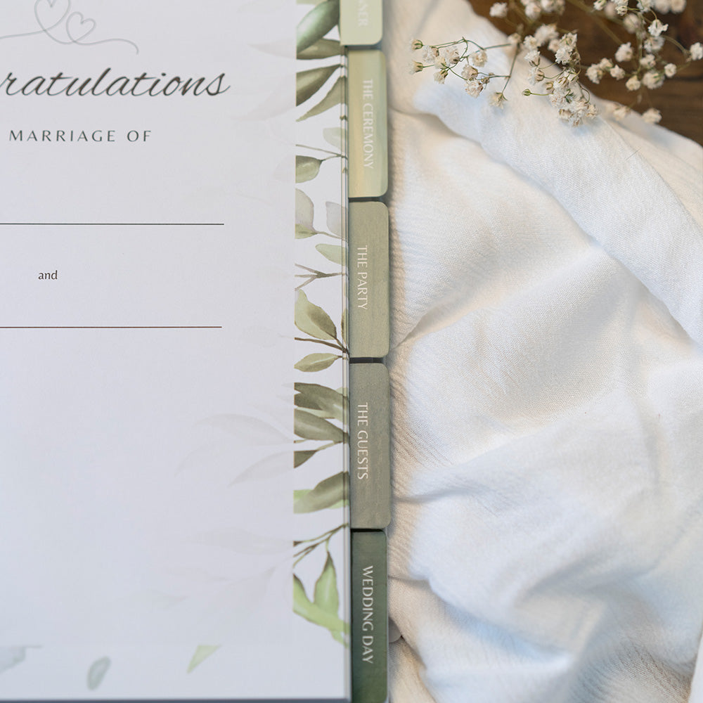 Wedding invitation with greenery design on a white background